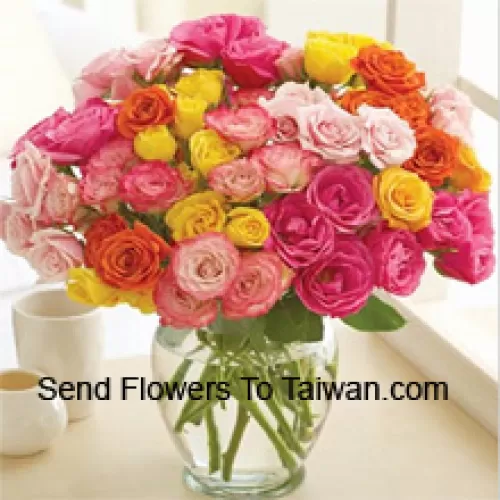 36 Mixed Colored Roses With Some Ferns In A Glass Vase