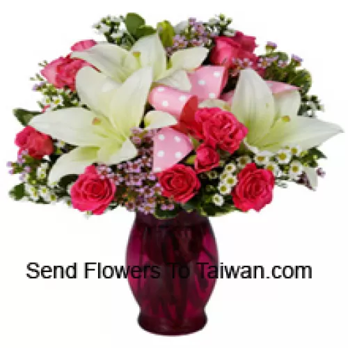 Pink Roses And White Lilies With Seasonal Fillers In A Glass Vase