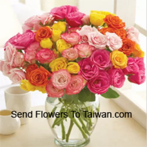 50 Mixed Colored Roses Arranged Beautifully In A Glass Vase