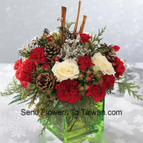 Send this bouquet of holiday colours - white roses, red carnations and Chinese New Year greens - to express your happiest holiday wishes. Arranged in a glass cube with cinnamon sticks and pinecones, it's a wonderful gift for anyone on your list (Please Note That We Reserve The Right To Substitute Any Product With A Suitable Product Of Equal Value In Case Of Non-Availability Of A Certain Product)